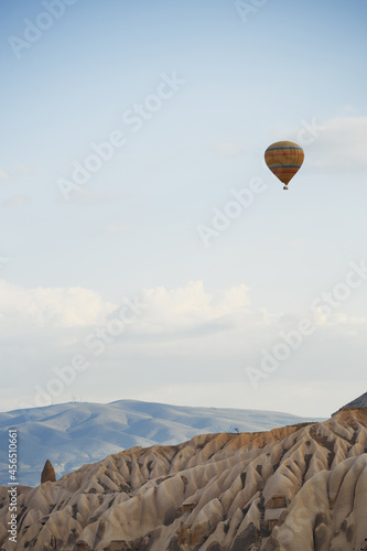 Hot air balloon flying over the rocky land