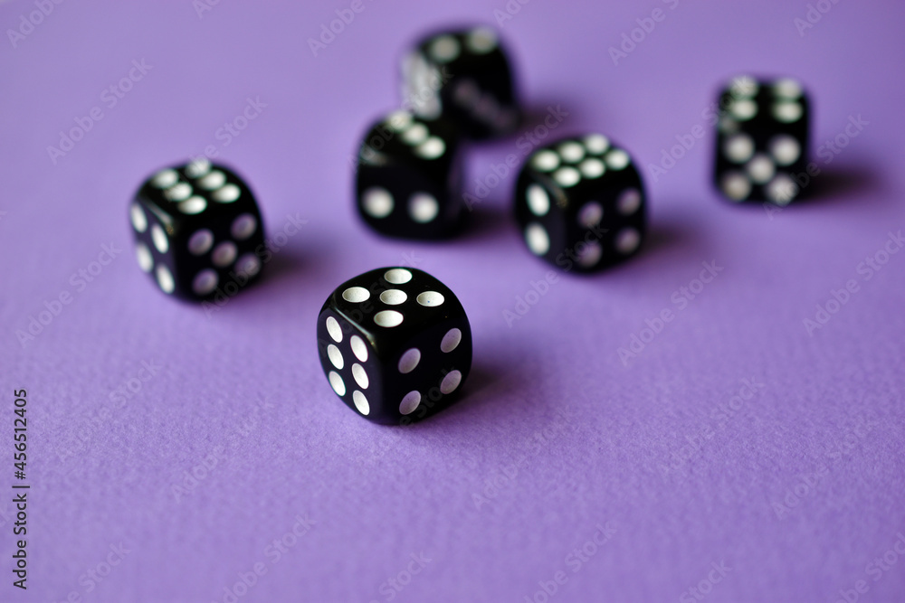 Dice are black and white on a purple background Dice are black and white on a purple background