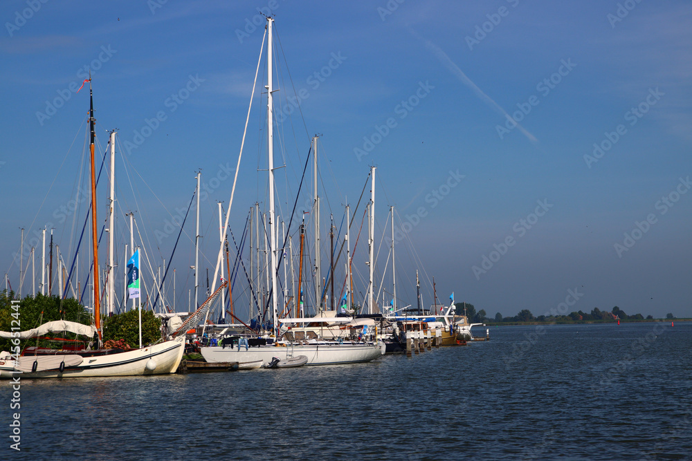 Sea bay with yachts. Sailboats on water, blue seawater, clear sky. Harbor of Monnickendam, the Netherlands.  