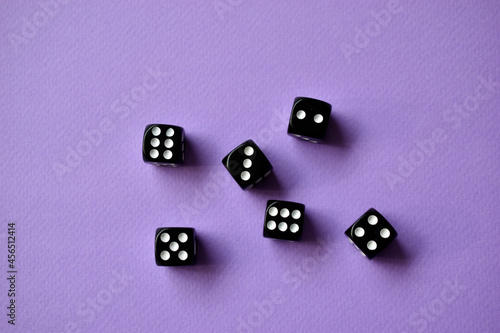 Dice are black and white on a purple background
