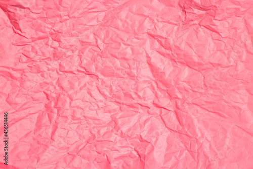 Crumpled pink paper abstract background texture