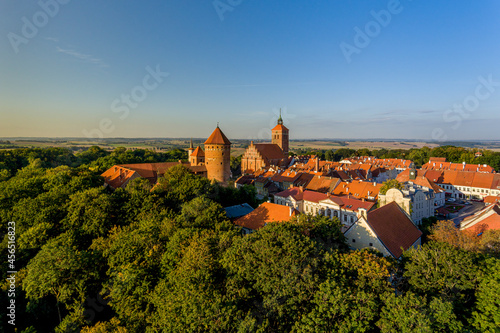 Panorama of the city of Reszel at sunrise, Castle and the Church of the Holy Apostles Peter and Paul in Reszel - Warmia and Masuria, Poland