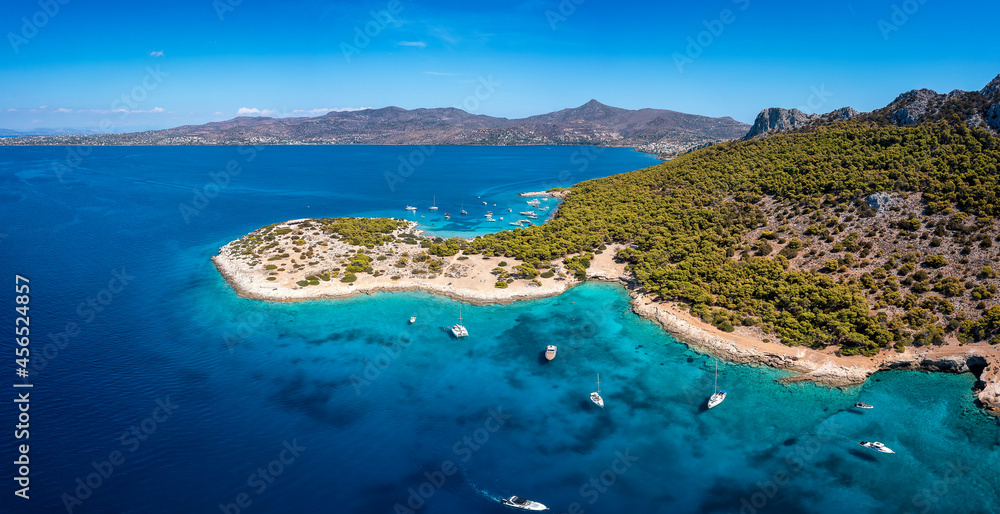 The beautiful coast of Moni island, next to Aigina in the Saronic Gulf of Athens with turqoise sea and lush, green hills