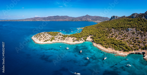 Fototapeta Naklejka Na Ścianę i Meble -  The beautiful coast of Moni island, next to Aigina in the Saronic Gulf of Athens with turqoise sea and lush, green hills