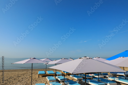 Many beach umbrellas and sunbeds at resort