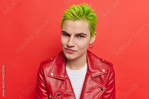 Valokuva Photo of hipster girl with trendy green hairstyle belongs to youth subculture has unique style