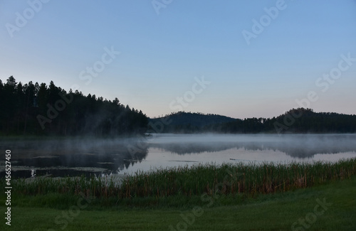 Fototapeta Naklejka Na Ścianę i Meble -  Fog Rising Off of Lake as the Sunrises