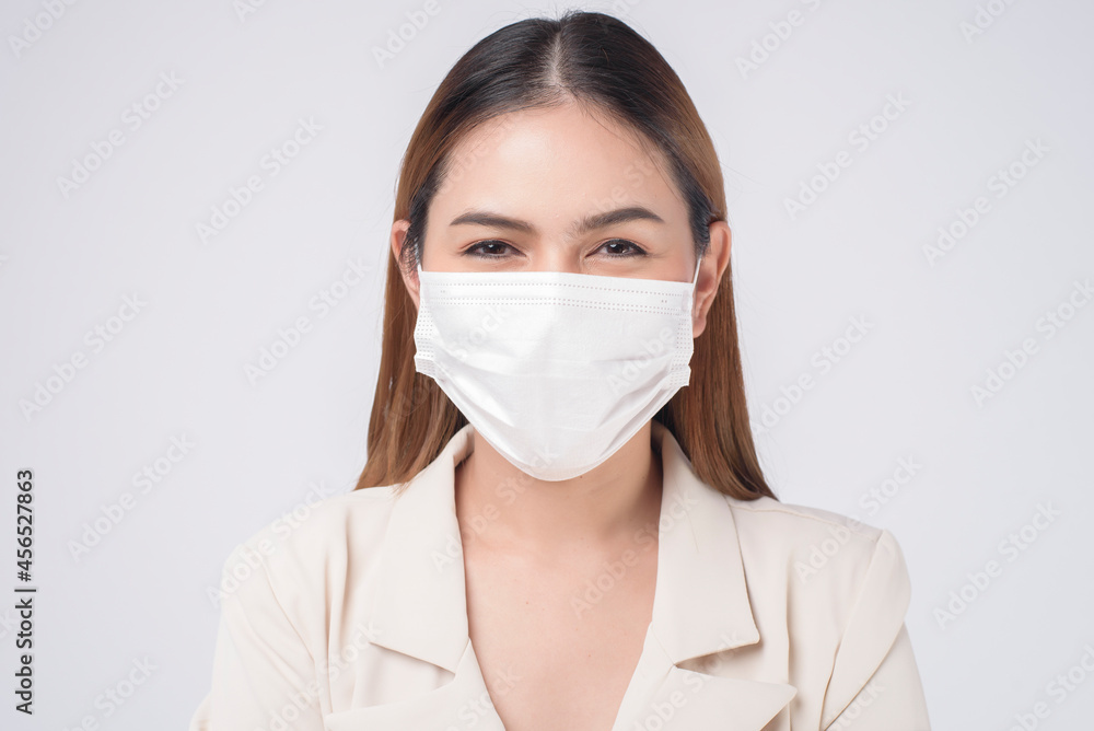 portrait of young businesswoman wearing a surgical mask over white background studio portrait of young businesswoman wearing a surgical mask over white background studio