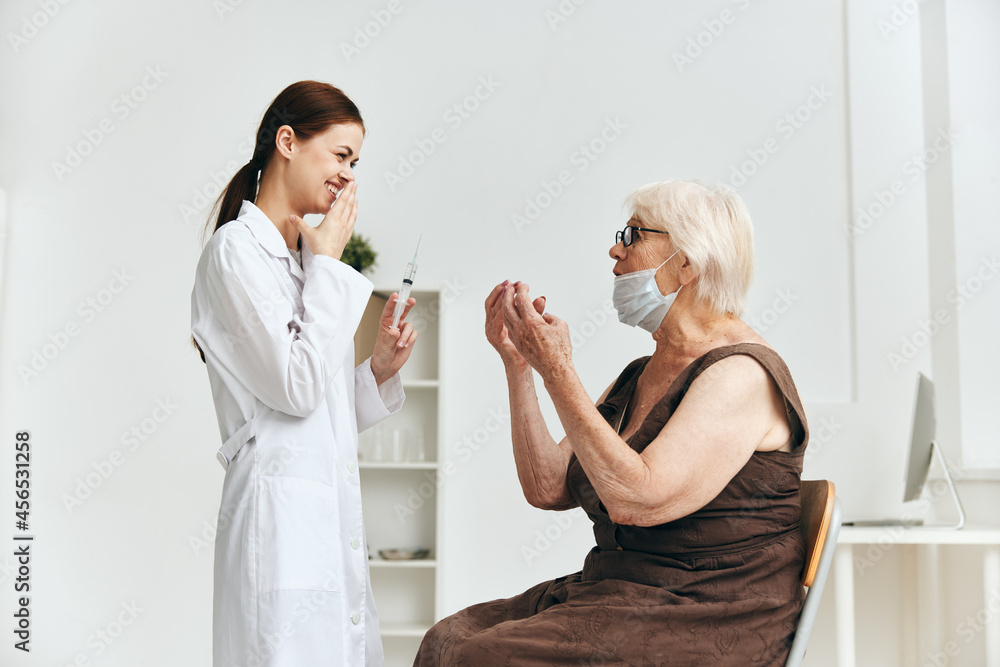 Nurse giving an injection to an elderly woman vaccination vaccine passport Nurse giving an injection to an elderly woman vaccination vaccine passport