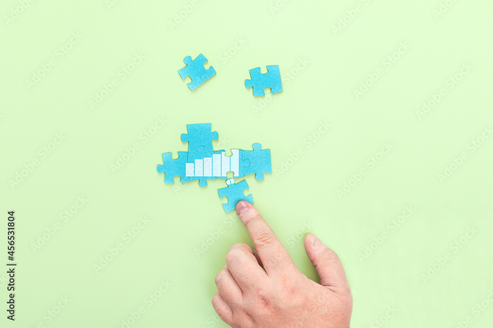 Businessman connecting pieces of a puzzle Businessman connecting pieces of a puzzle