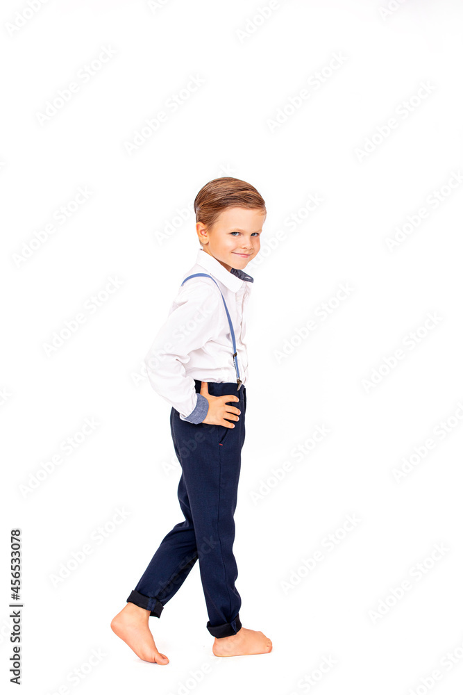 Fototapeta premium Cute boy child stylish in a white shirt on a white isolated background