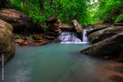 Native picturesque waterfall,Small Waterfall in deep forest,Ubon Ratchathani province,Thailand.leaf moving low speed shutter blur.