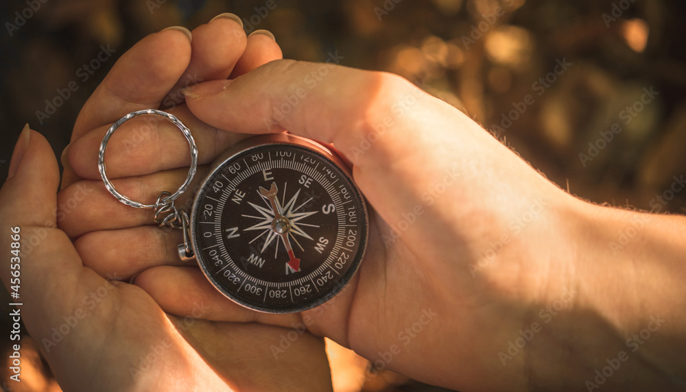 Woman hands with compass in the forest, close-up view photo Woman hands with compass in the forest, close-up view photo