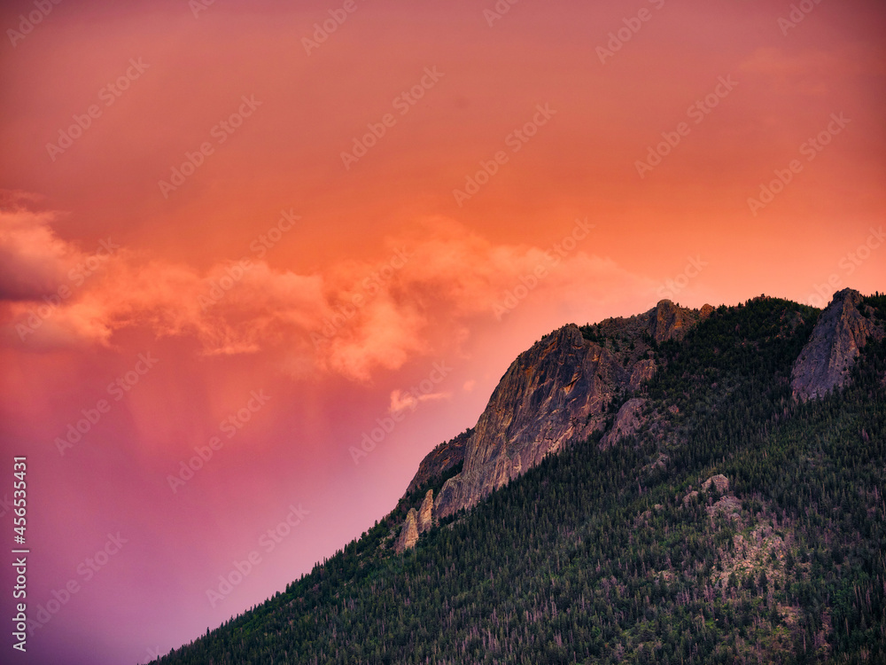 Pink and Orange sunset after glow on a mountain face in the Rocky Mountains