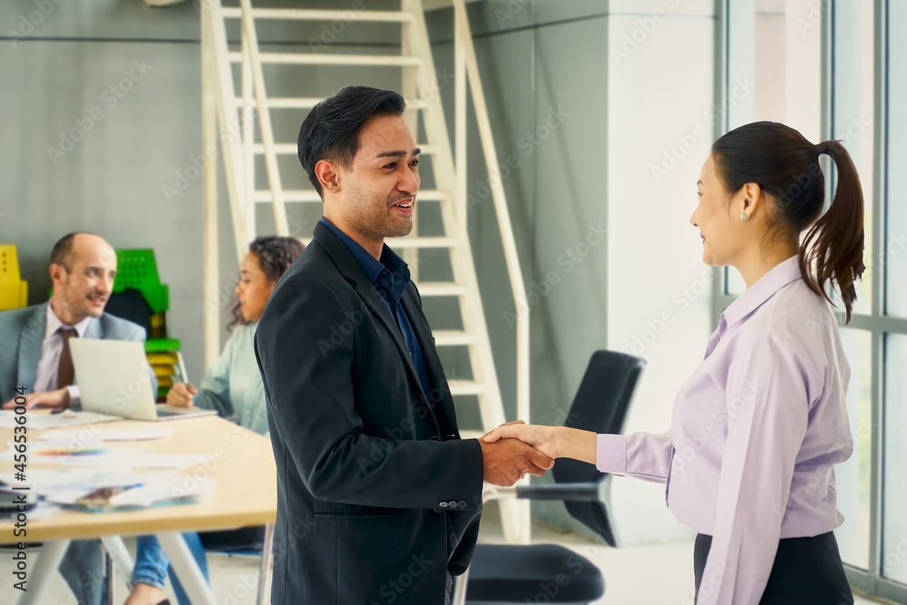 Businessman and new employee female shake hand in meeting room for new hiring work Businessman and new employee female shake hand in meeting room for new hiring work