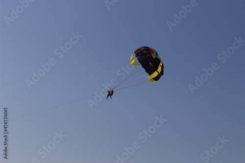 Parachute flying is one of the types of entertainment at seaside resorts. The boat pulls a parachute on a zip line.