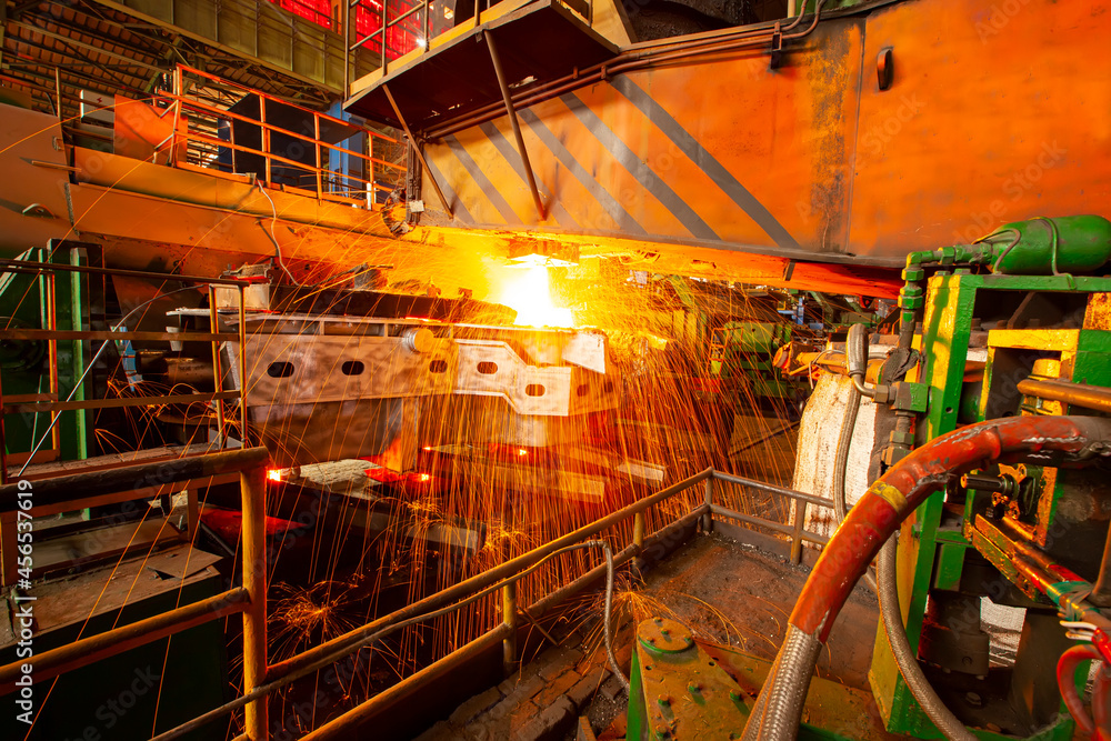 steelworker at work pouring metal in the workshop, Steelmaking workshop