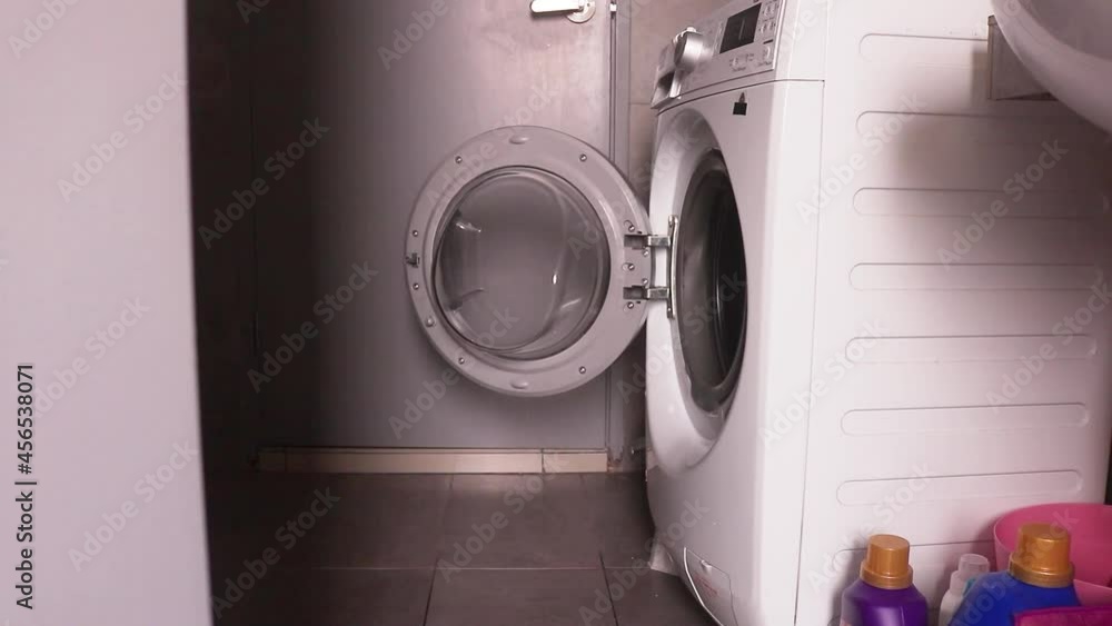 Woman In Pajamas Standing Up After Opening Washing Machine Door Woman In Pajamas Standing Up After Opening Washing Machine Door