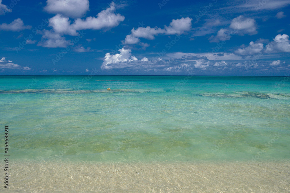Crystal clear waters and pinkish sands on empty seven mile beach on tropical carribean Grand Cayman Island