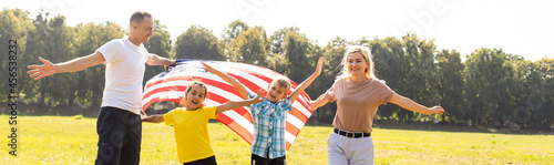 Happy family in field with USA, american flag © Angelov