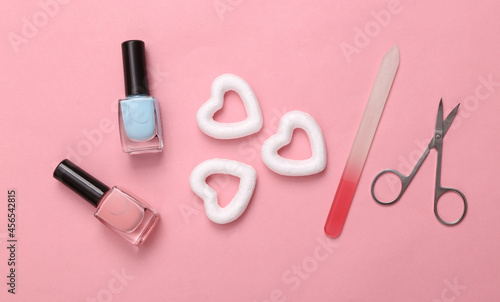 Cosmetic accessories with hearts on pink background. Minimal beauty layout. Top view