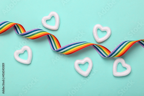 Lgbt rainbow flag symbol ribbon with hearts on blue background. Freedom love concept