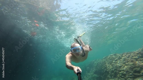 underwater man snorkeling in the sea withcrystal-clear waters concept of holiday relax summer beach diver in the sea