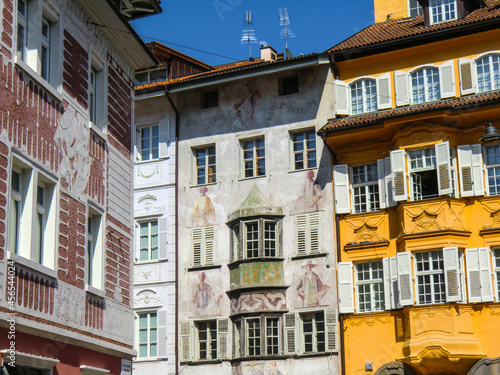Bolzano, Bozen, August 2021, Dolomites, Alpine mountain region, South Tirol, Alto Adige, Row of houses, Painted walls, Street, Town, Italia, Italy, Europe.