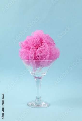 Sponge in cocktail glass on blue background. Fresh idea. Minimal party concept, creative layout