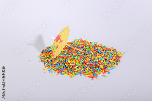 Umbrella and colored sprinkles on a gray background. Minimal layout © splitov27