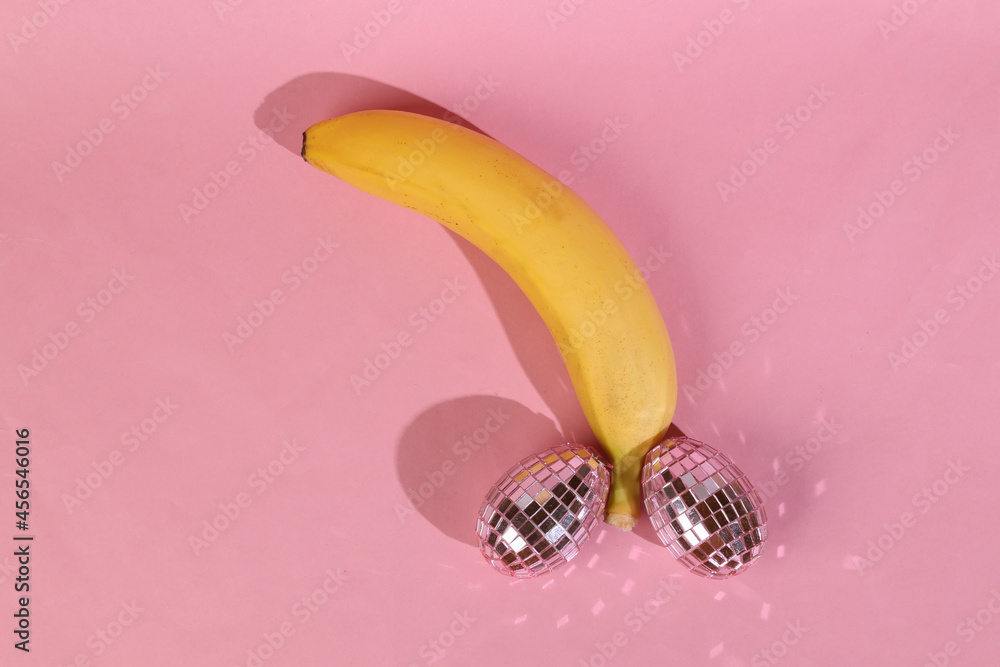 Panan with mirrored eggs on a pink background. Male genital shape