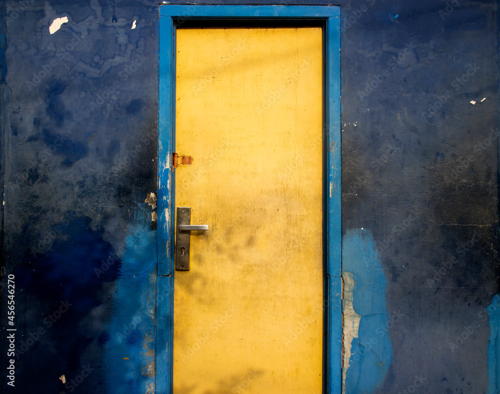 blue wall with yellow door.