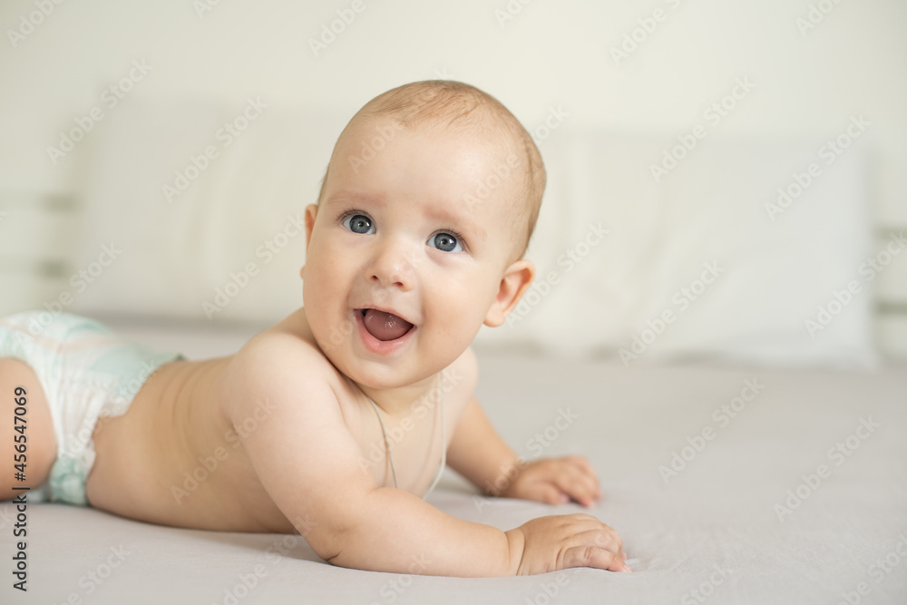 Portrait of a crawling baby on the bed in her room Portrait of a crawling baby on the bed in her room