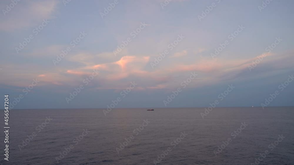 Boat Silhouettes while refill fuel at Sunset Over Sea.Orange Red Color Sunrise dramatic sky adn clouds On Horizon. Boat Silhouettes while refill fuel at Sunset Over Sea.Orange Red Color Sunrise dramatic sky adn clouds On Horizon.
