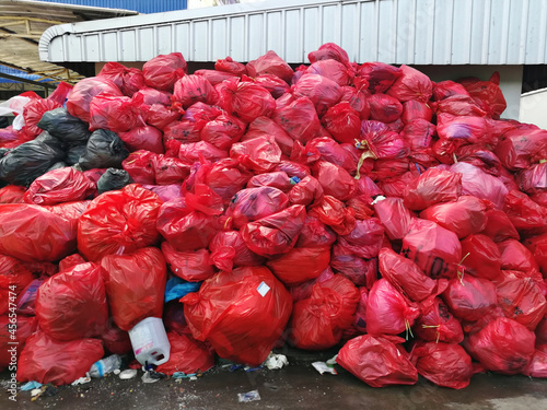 group of infectious waste from covid 19 patient in red plastic bag