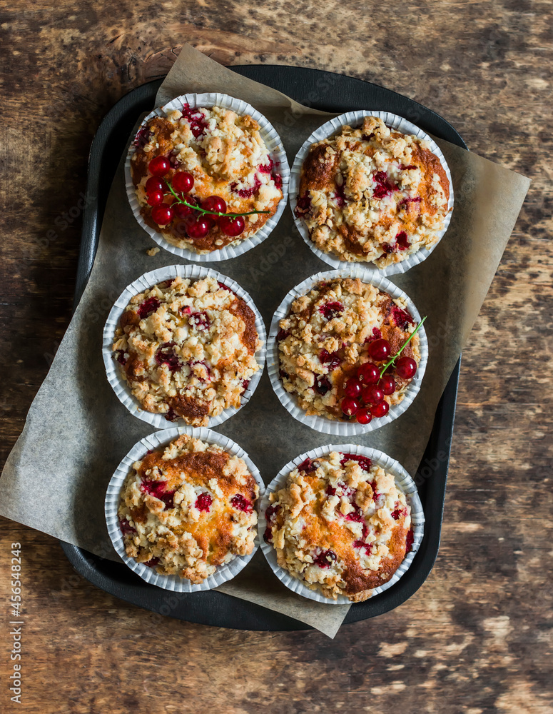 Red currant mini cakes with lemon crumble on a wooden background, top view Red currant mini cakes with lemon crumble on a wooden background, top view