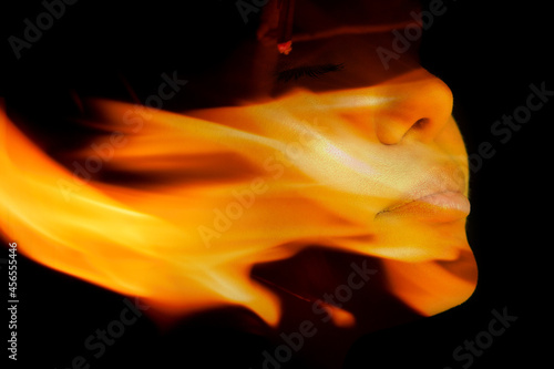 Obraz na plátně A portrait of a pretty woman combined with a close up photograph of a flame