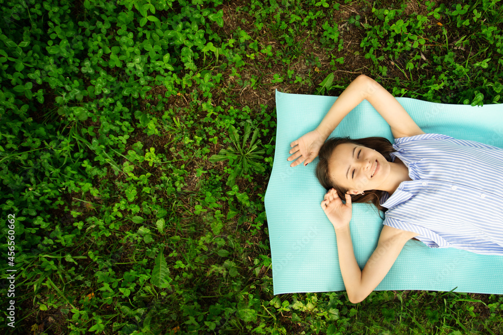 Φωτογραφία happy teenager,top view of young smiling woman lying on the grass,happiness and