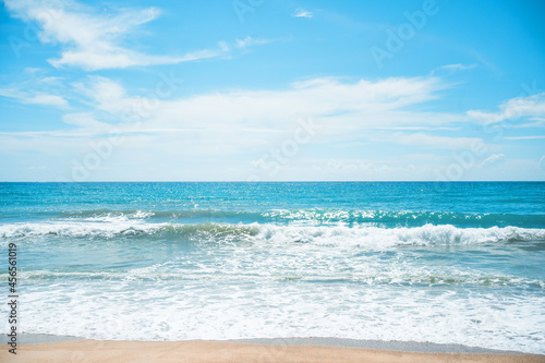 Landscape waves nature splashes beach sunlight.Blue sea waves and sky on sand famous beach.clean sea white clouds soft daylight.