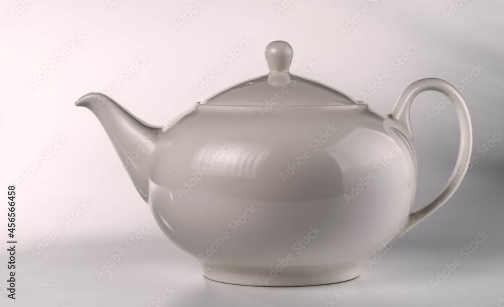 Light gray ceramic teapot on a light background. Light gray ceramic teapot on a light background.