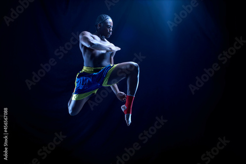 Obraz na plátně Young male boxer poised in mid air