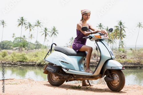 Foto Young woman on moped