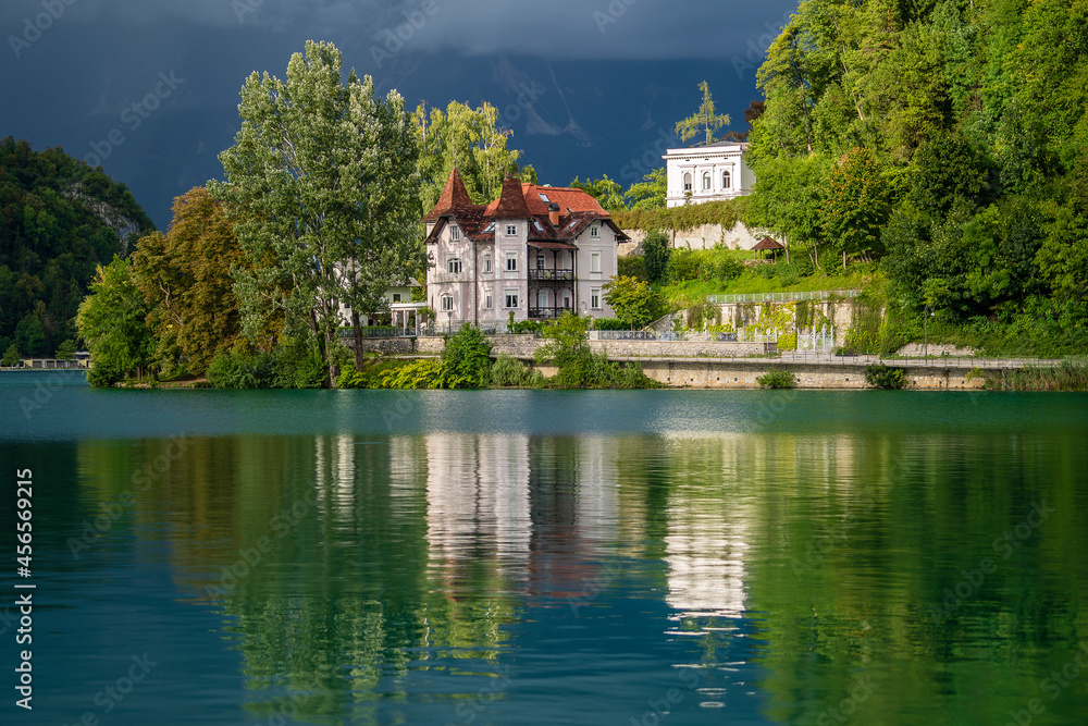 Bled lake and buildings in cloudy weather before rain and thunderstorms , Slovenia, Europe