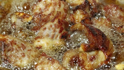 close up scene of frying pork and in boiling hot oil, 4K