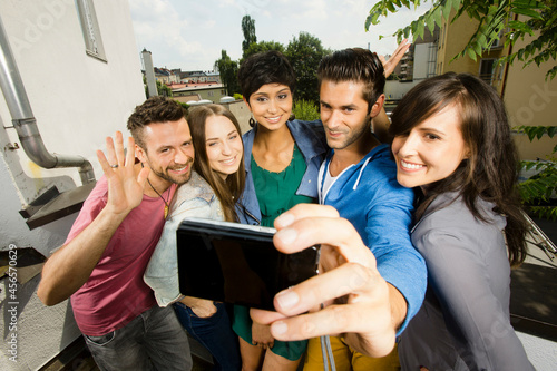 Canvas Print Five friends photographing themselves on camera phone