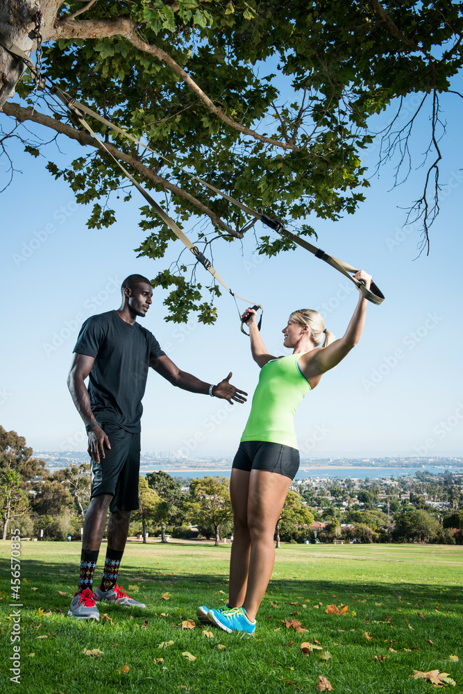 Young woman and trainer using lunge rope in park Young woman and trainer using lunge rope in park