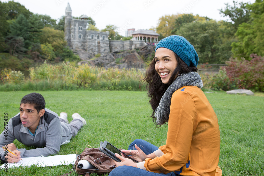 Fototapeta premium Students sitting in park doing homework