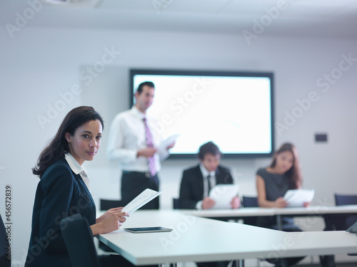 Portrait of businesswoman in meeting room with screen