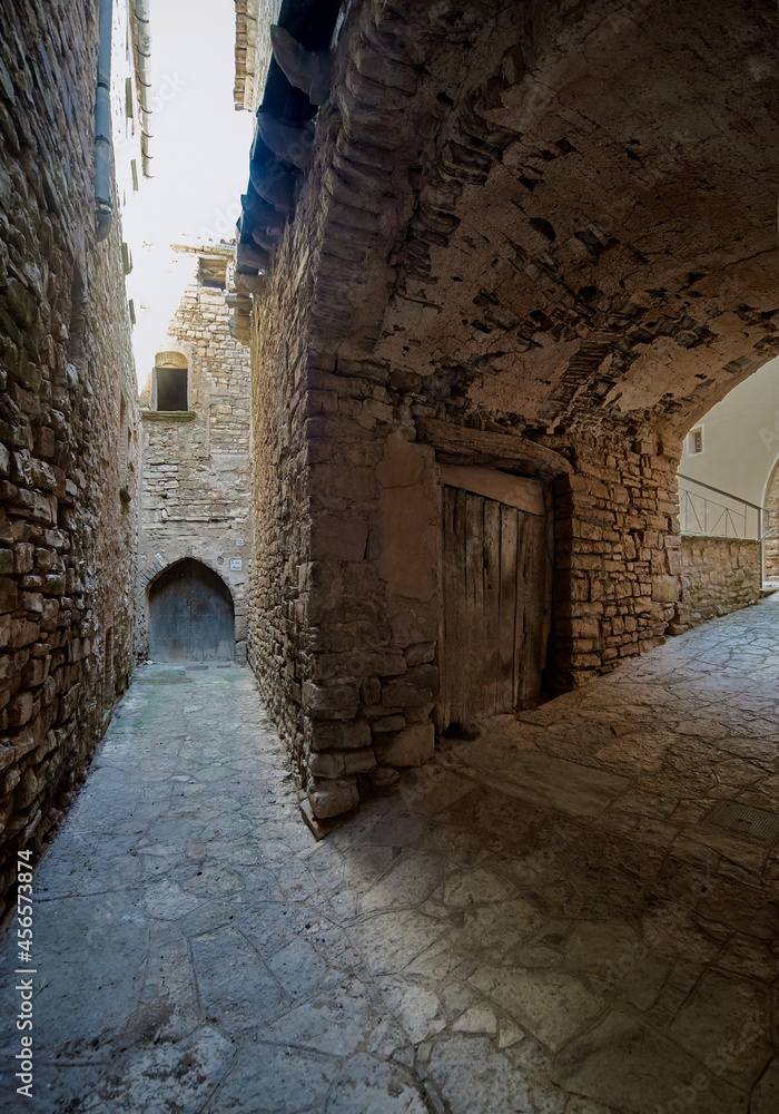 alley divided in two surrounded by stone walls