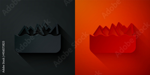 Paper cut Sharp stone reefs protruding from the sea, a danger to sea ships and vessels icon isolated on black and red background. Paper art style. Vector